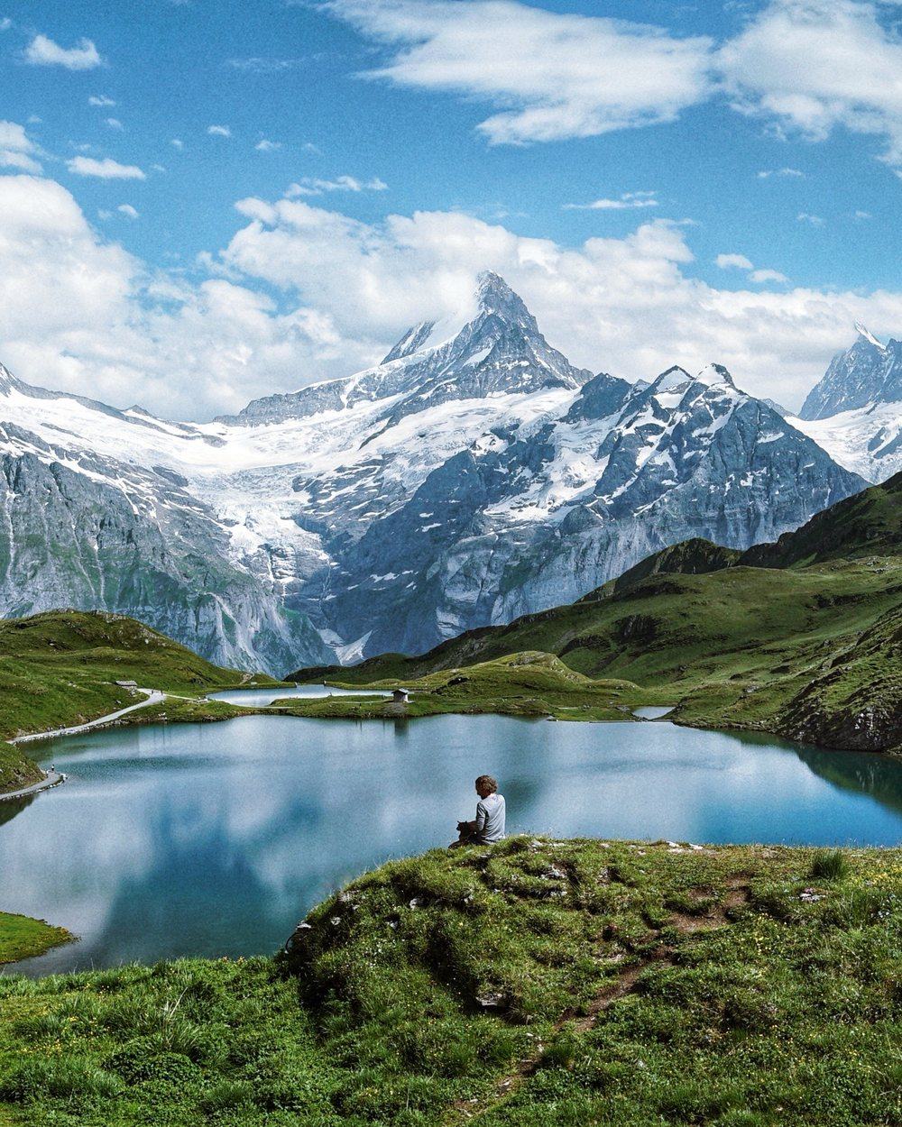 Christian sitting by a mountain lake in the Alps